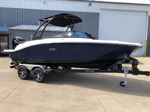Sea Ray SPX 190 Outboard 2023 Sea Ray 190 SPO boat on a trailer outside a warehouse.