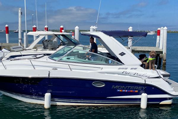 Monterey 295 Sport Yacht 2022 Monterey 295 Sport Yacht docked with passengers on board.