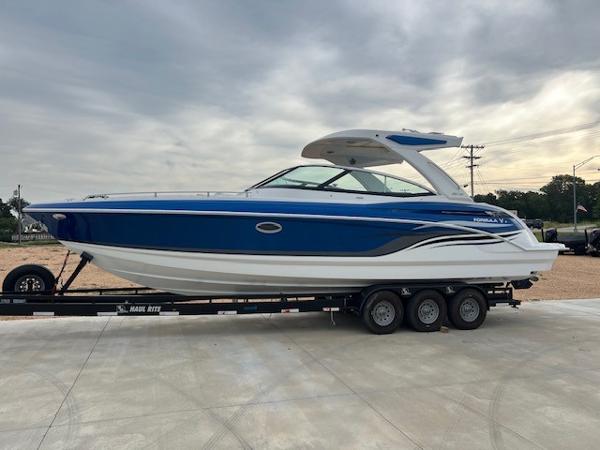Formula 330 Crossover Bowrider I/O 2025 Formula 330 Crossover Bowrider I/O boat on trailer, blue and white design.