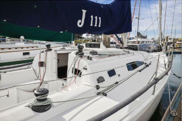 J Boats J/111 2013 J Boats J/111 sailboat docked at marina, featuring sleek white design.