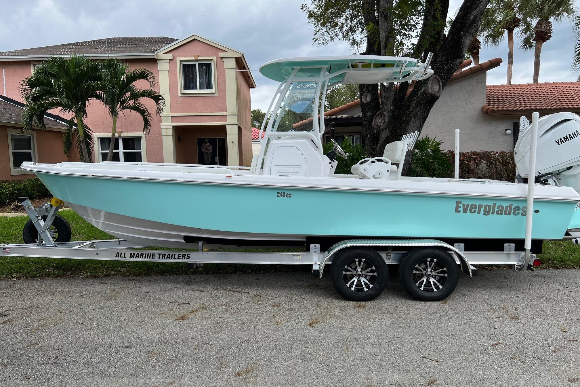 Everglades 243 Center Console 2022 Everglades 243 Center Console boat on trailer, parked in residential area.