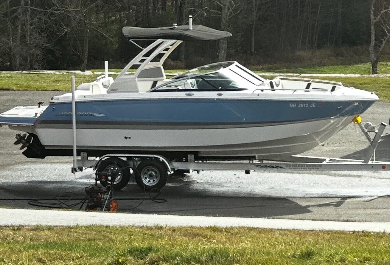 Chaparral 247 SSX 2022 Chaparral 247 SSX boat on trailer, parked outdoors.