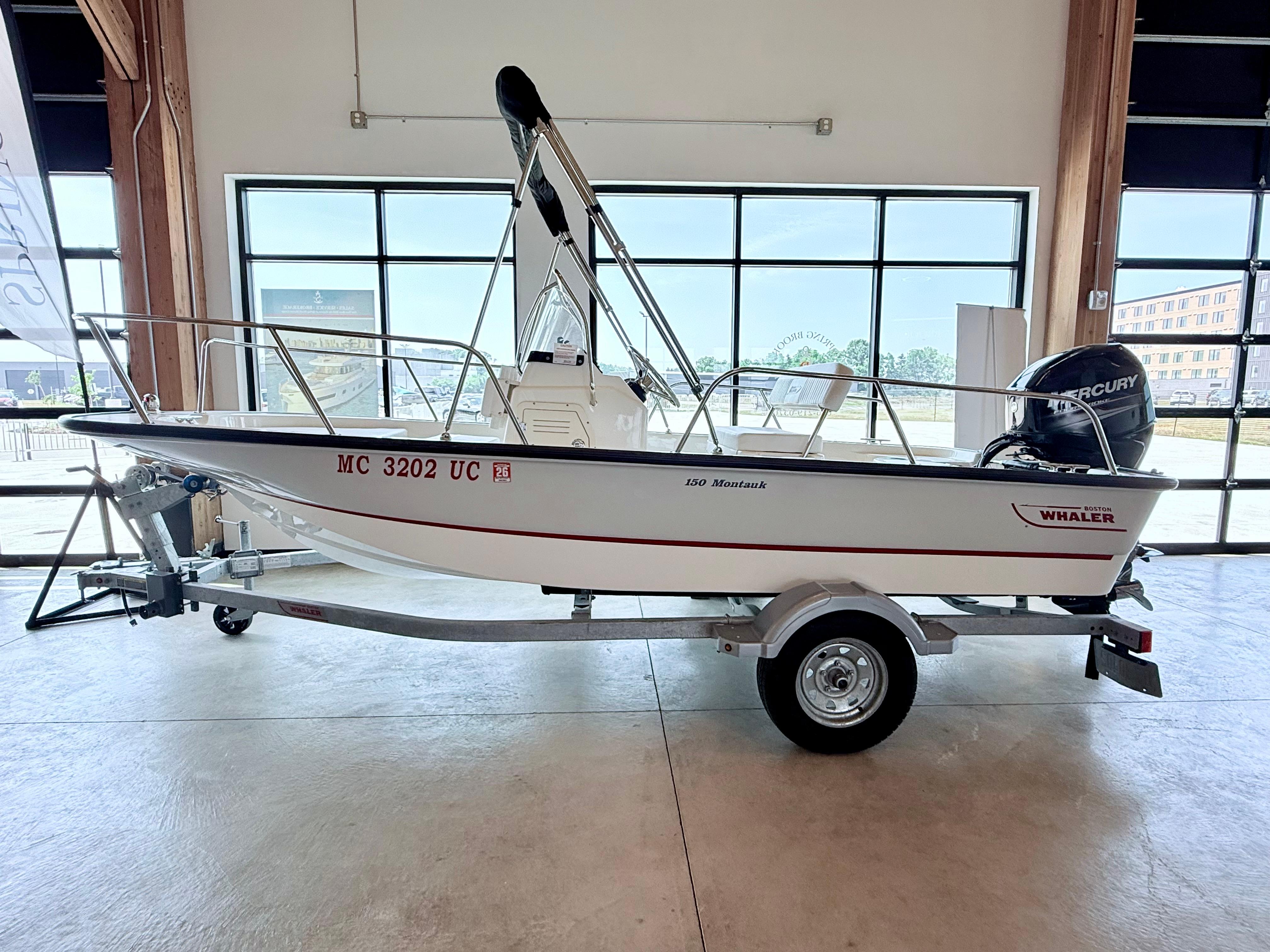 Boston Whaler 150 Montauk 2017 Boston Whaler 150 Montauk boat on trailer in showroom.
