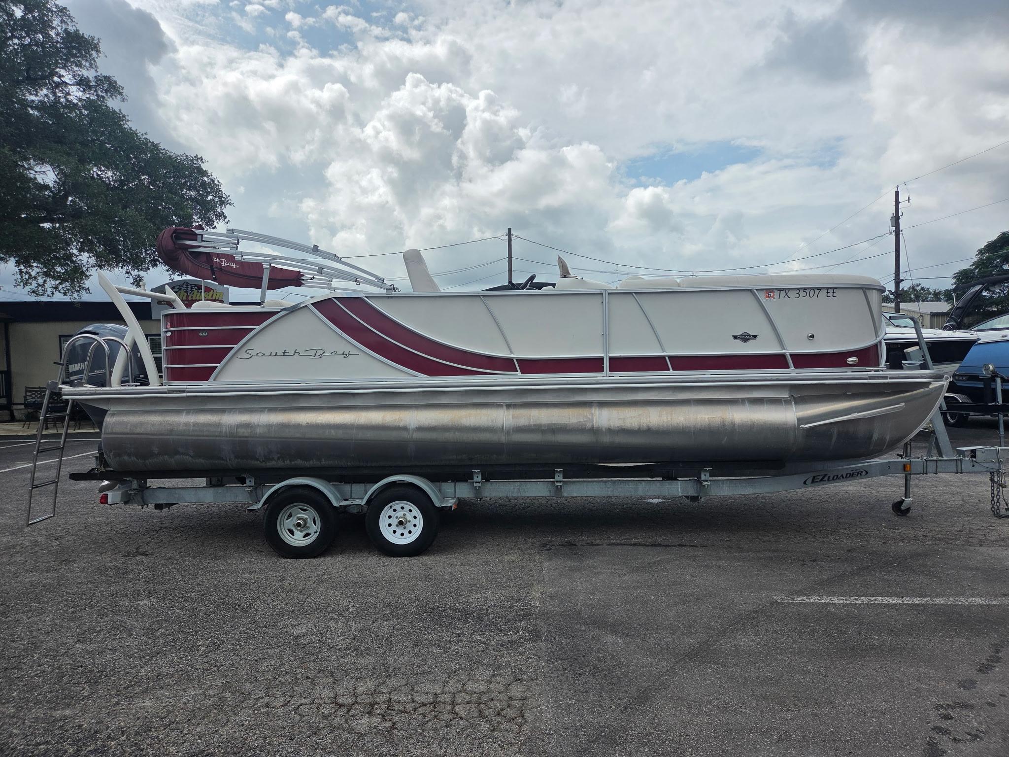 South Bay 523 CR 2017 South Bay 523 CR pontoon boat on trailer, parked outdoors.