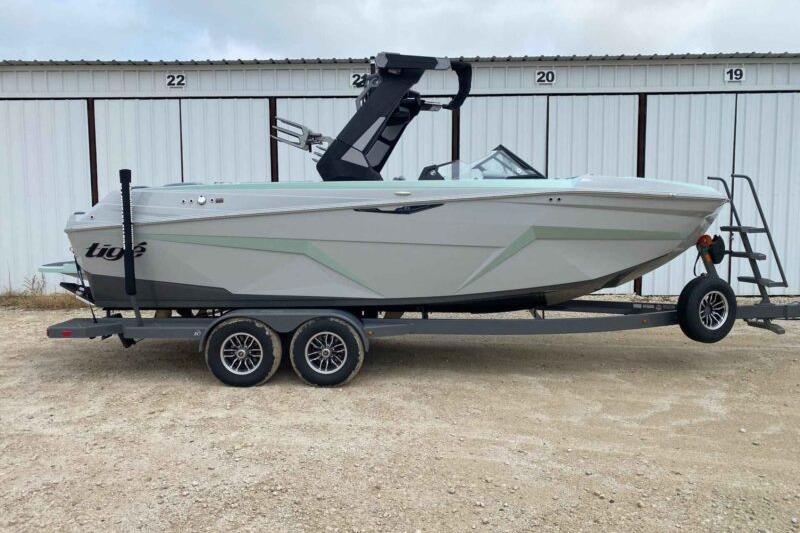 Tigé Z3 2026 Tigé Z3 boat on trailer, parked in front of storage units.