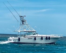 Bertram 46 Moppie 1994 Bertram 46 Moppie yacht cruising on blue ocean waters.