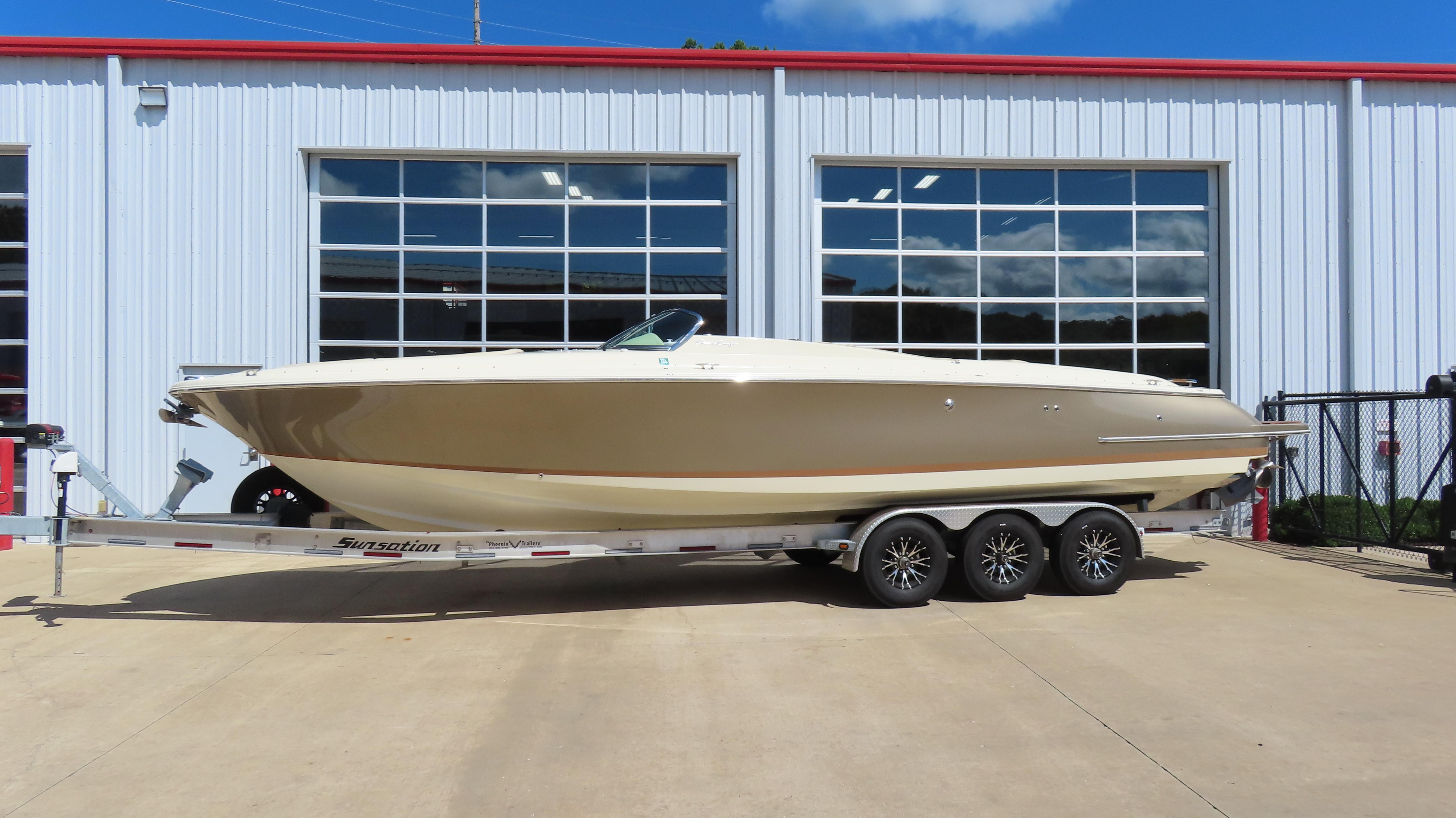 Chris-Craft Launch 34 2018 Chris-Craft Launch 34 boat on trailer, parked outside a building.