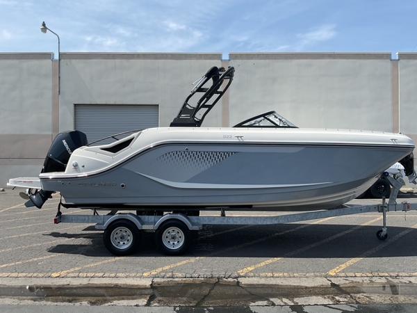 Bayliner D22 2025 Bayliner D22 boat on trailer, sleek design, parked outdoors.