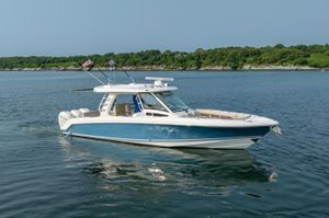 Boston Whaler 350 EX REALM 2019 Boston Whaler 350 EX REALM boat cruising on calm water with lush green shoreline.