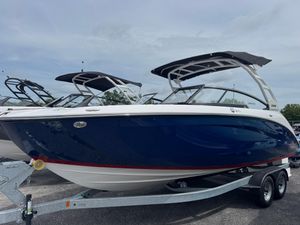 Yamaha Boats 252SD 2025 Yamaha Boats 252SD on trailer, sleek design, blue hull, black canopy.