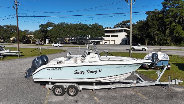 Century 24 Center Console 2005 Century 24 Center Console boat on trailer, labeled "Salty Dawg II," parked outdoors.
