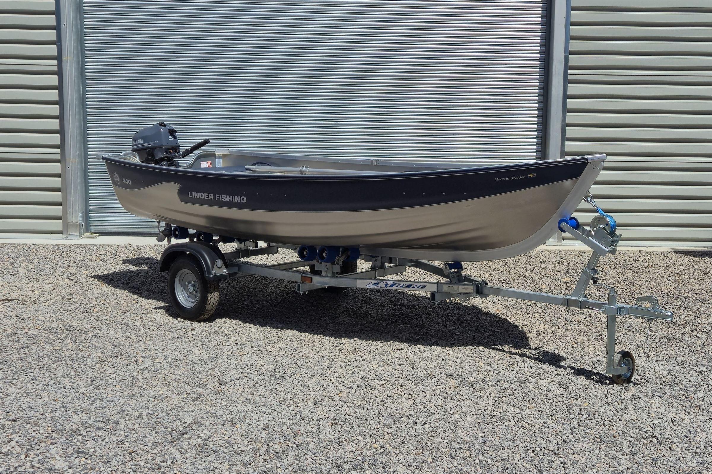 Linder Fishing 440 2022 Linder Fishing 440 boat on trailer, parked outside a metal building.