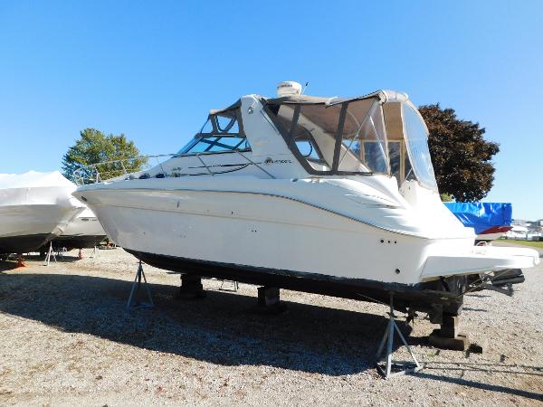 Sea Ray 370 Sundancer 1999 Sea Ray 370 Sundancer boat on stands, clear sky background.