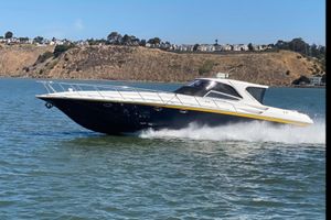 Fountain 48 Express Cruiser 2005 Fountain 48 Express Cruiser speeding on water with scenic hillside background.