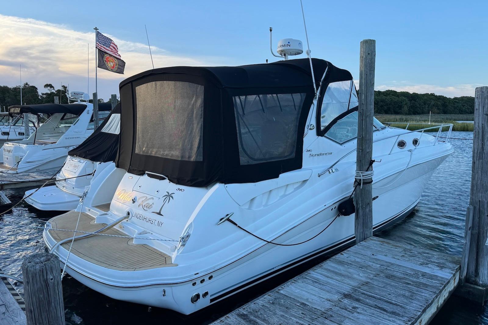 Sea Ray 340 Sundancer 2005 Sea Ray 340 Sundancer docked at marina with American flag.