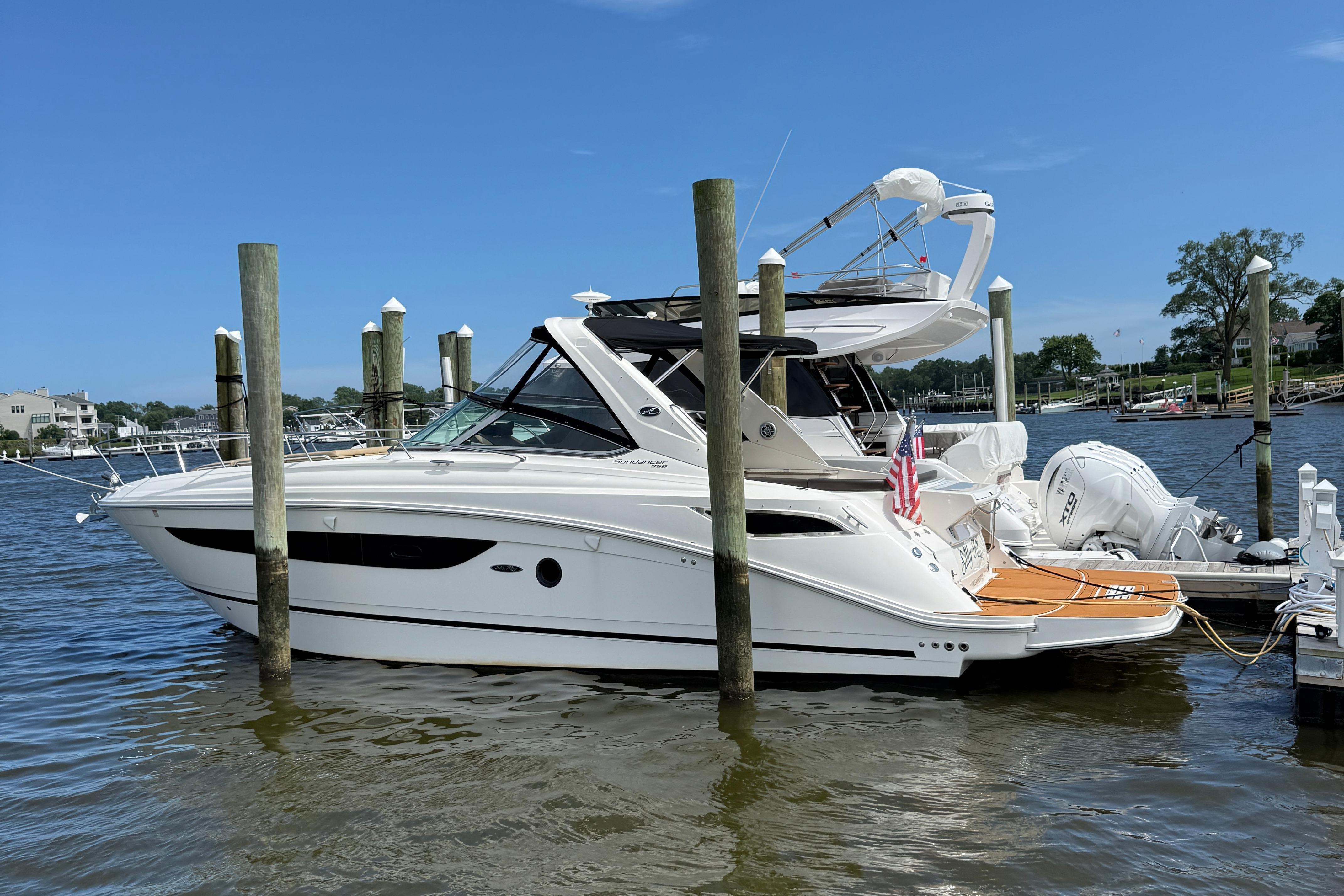Sea Ray 350 Sundancer 2015 Sea Ray 350 Sundancer yacht docked at marina, clear blue sky.