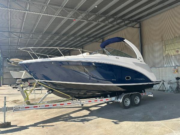 Regal 26XO 2025 Regal 26XO boat on trailer in covered storage facility.