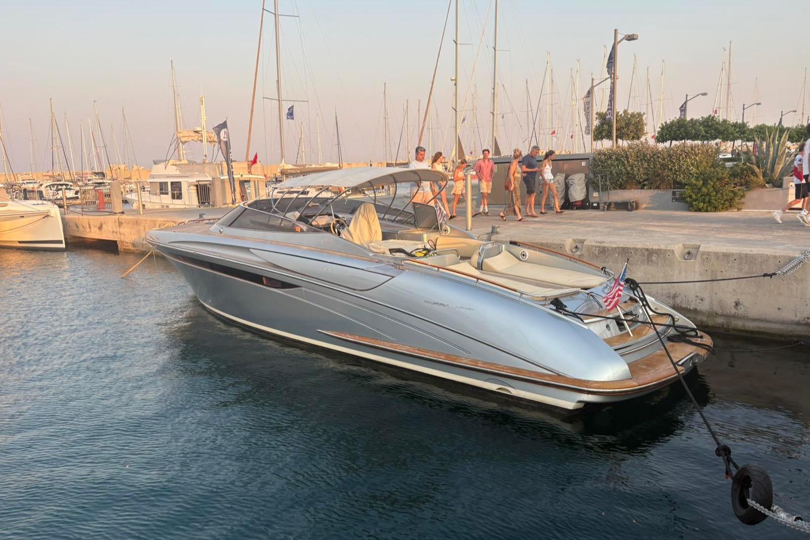 Riva Rivarama Super 44 2014 Riva Rivarama Super 44 yacht docked at marina with people nearby.
