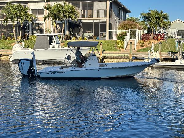 Key West 230 Bay Reef 2017 Key West 230 Bay Reef boat docked in a sunny waterfront setting.