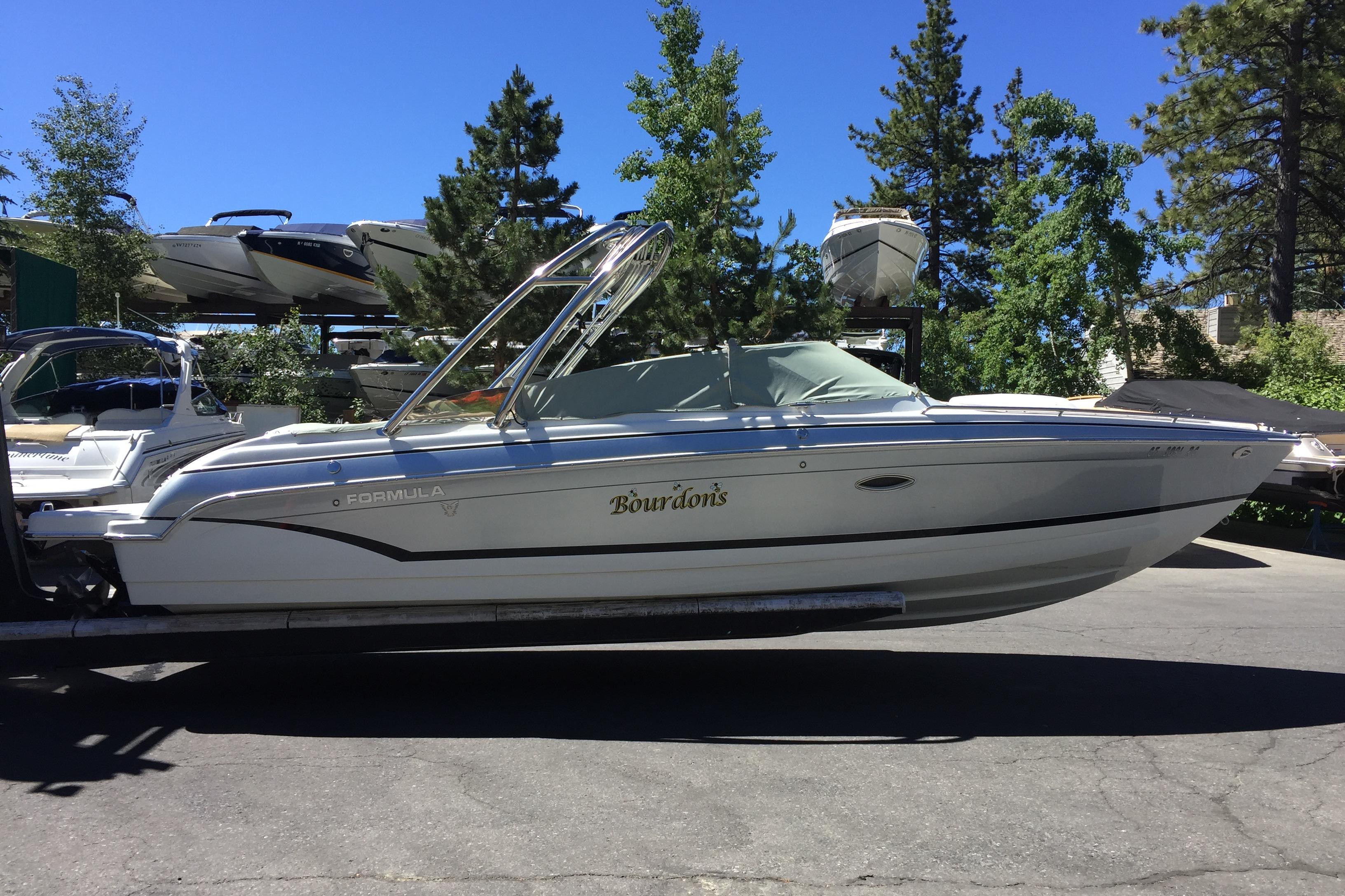 Formula 260 Bowrider 2007 Formula 260 Bowrider boat on trailer, surrounded by trees and other boats.
