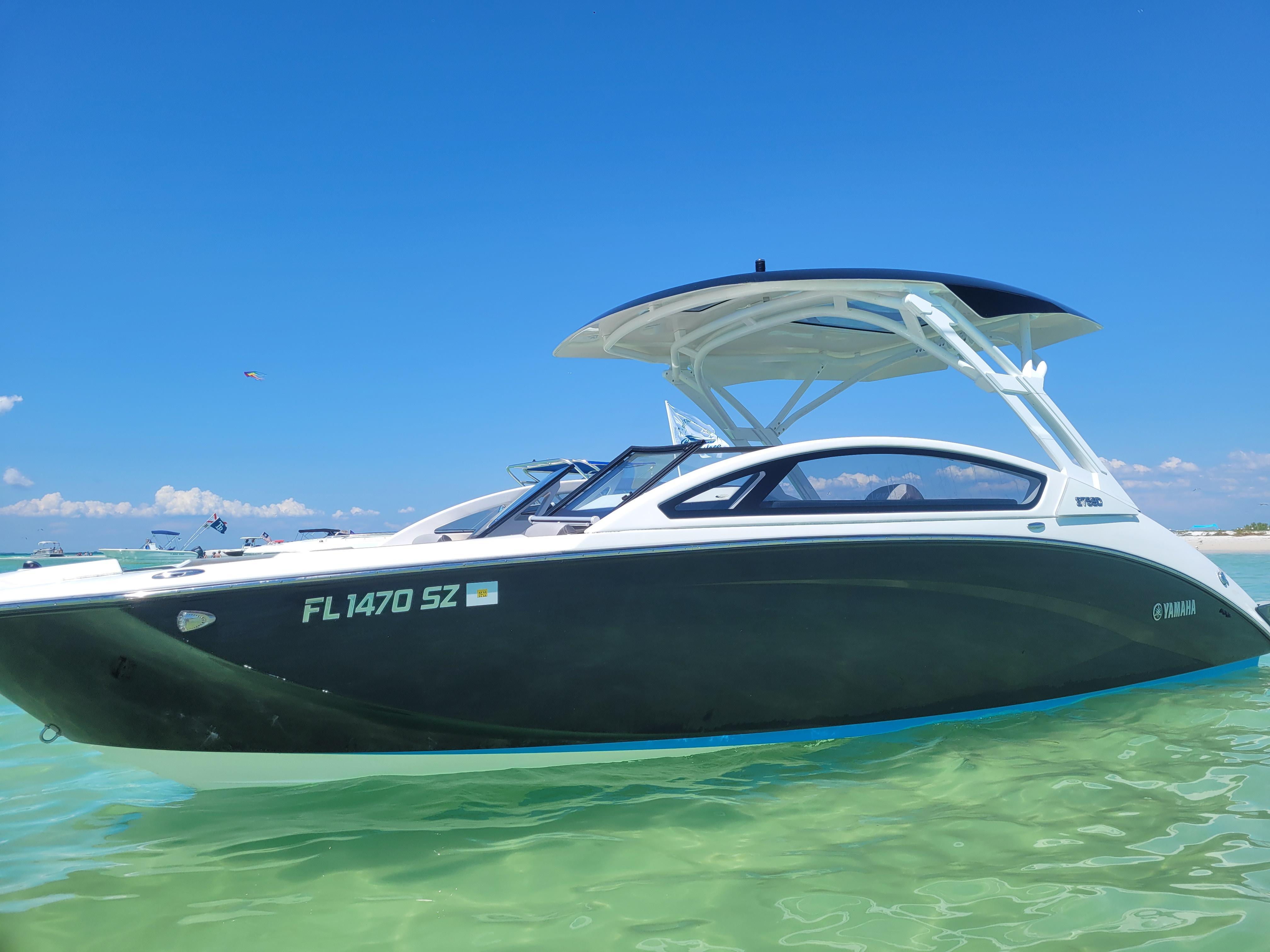 Yamaha Boats 275 SD 2021 Yamaha Boats 275 SD on clear water under blue sky.
