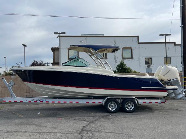 Chris-Craft Calypso 28 2024 Chris-Craft Calypso 28 boat on a trailer, side view.