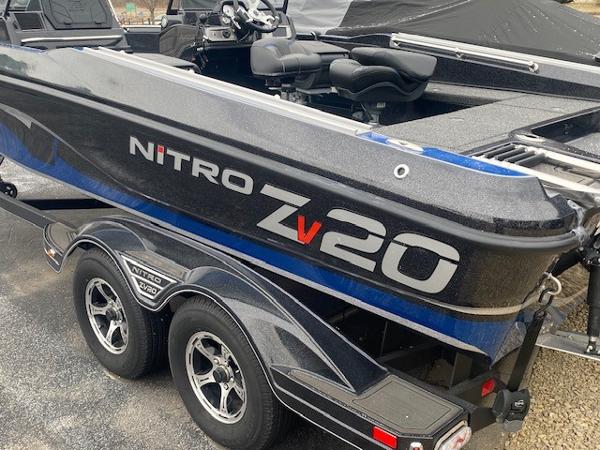Nitro ZV20 Pro 2024 Nitro ZV20 Pro boat on trailer, sleek design, black and blue color scheme.