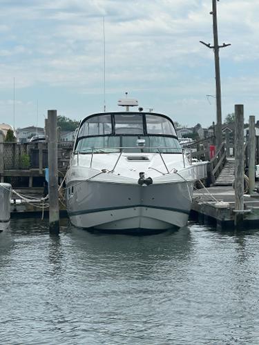 Rinker 320 EX 2020 Rinker 320 EX boat docked at a marina on a cloudy day.
