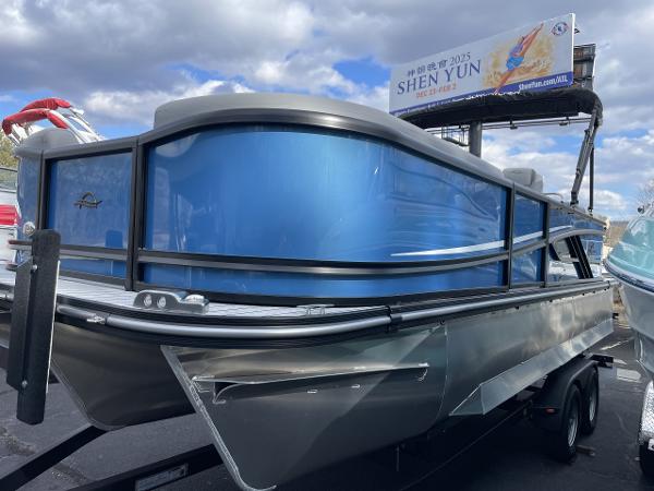 SunCatcher Fusion 322RC 2025 SunCatcher Fusion 322RC pontoon boat with sleek blue design on a trailer.