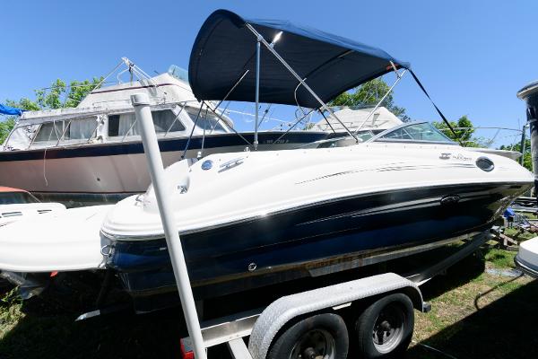 Sea Ray 240 Sundeck 2009 Sea Ray 240 Sundeck boat on trailer with canopy, parked outdoors.
