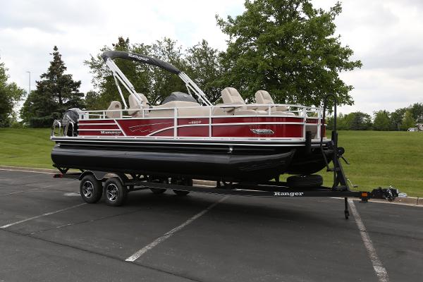 Ranger Reata 220F 2024 Ranger Reata 220F pontoon boat on trailer in parking lot.