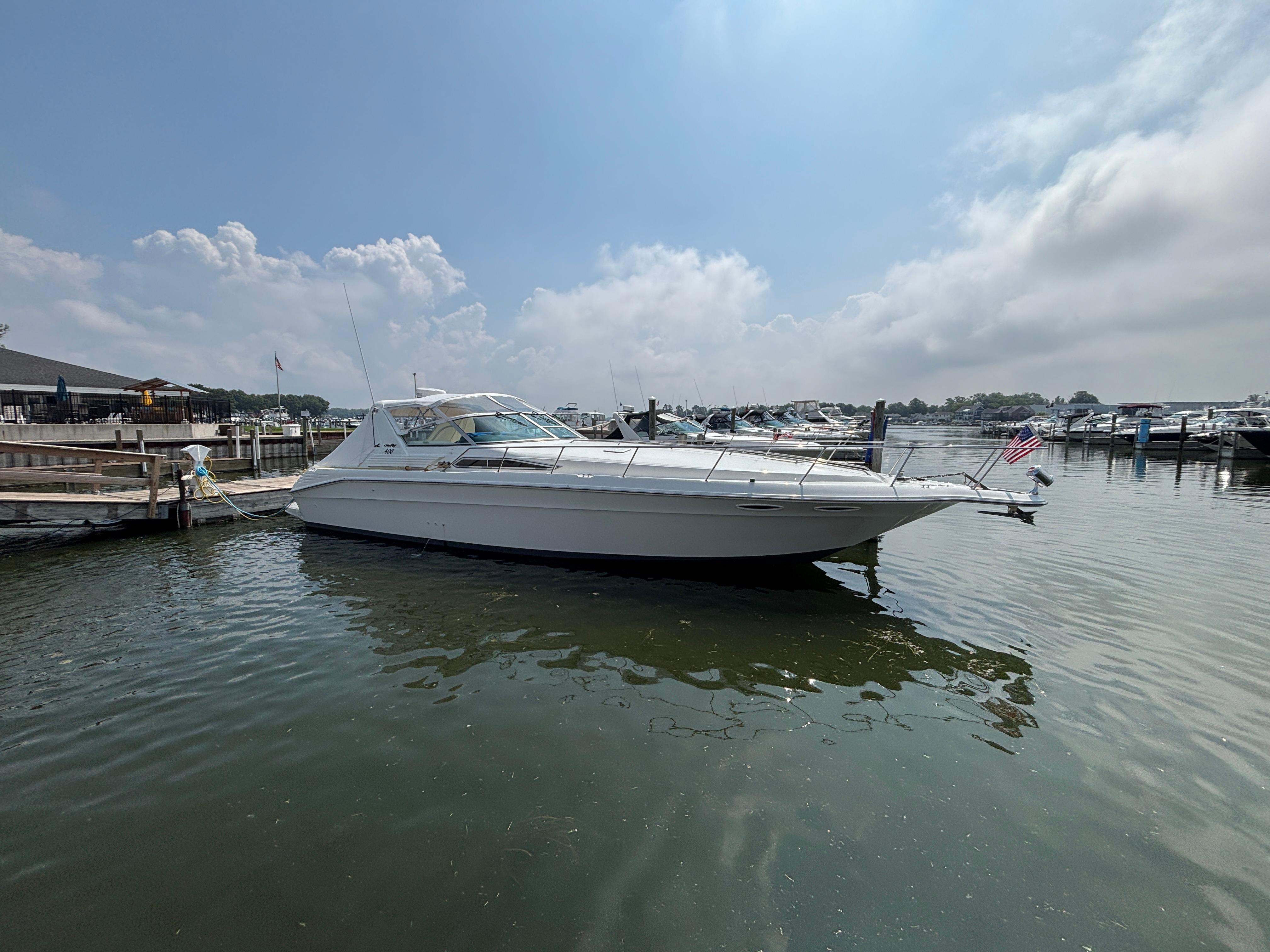 Sea Ray 400 Express Cruiser 1992 Sea Ray 400 EXPRESS yacht docked at marina under cloudy sky.
