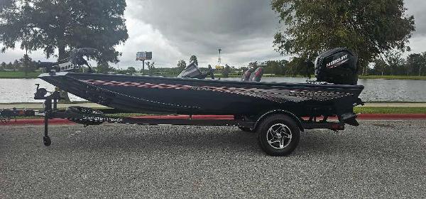 Ranger RT178C 2024 Ranger RT178C boat on trailer by a lake, overcast sky.