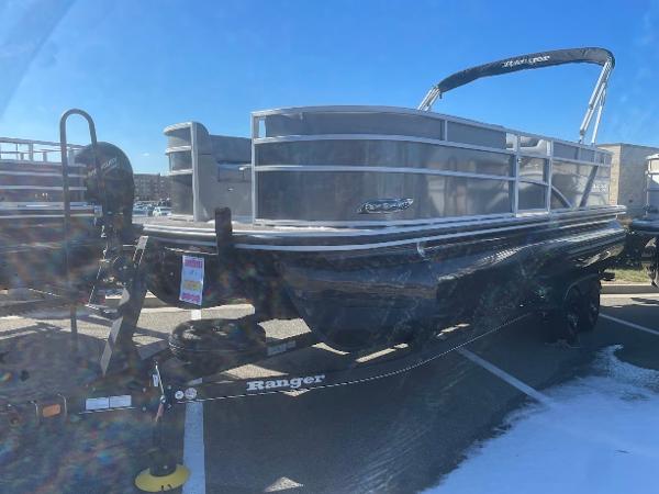 Ranger Reata 223C 2024 Ranger Reata 223C pontoon boat on trailer, parked outdoors under clear blue sky.