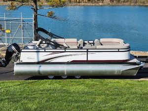 Qwest Angler Qwest XRE 2024 Qwest Angler Qwest XRE pontoon boat by a serene lake.
