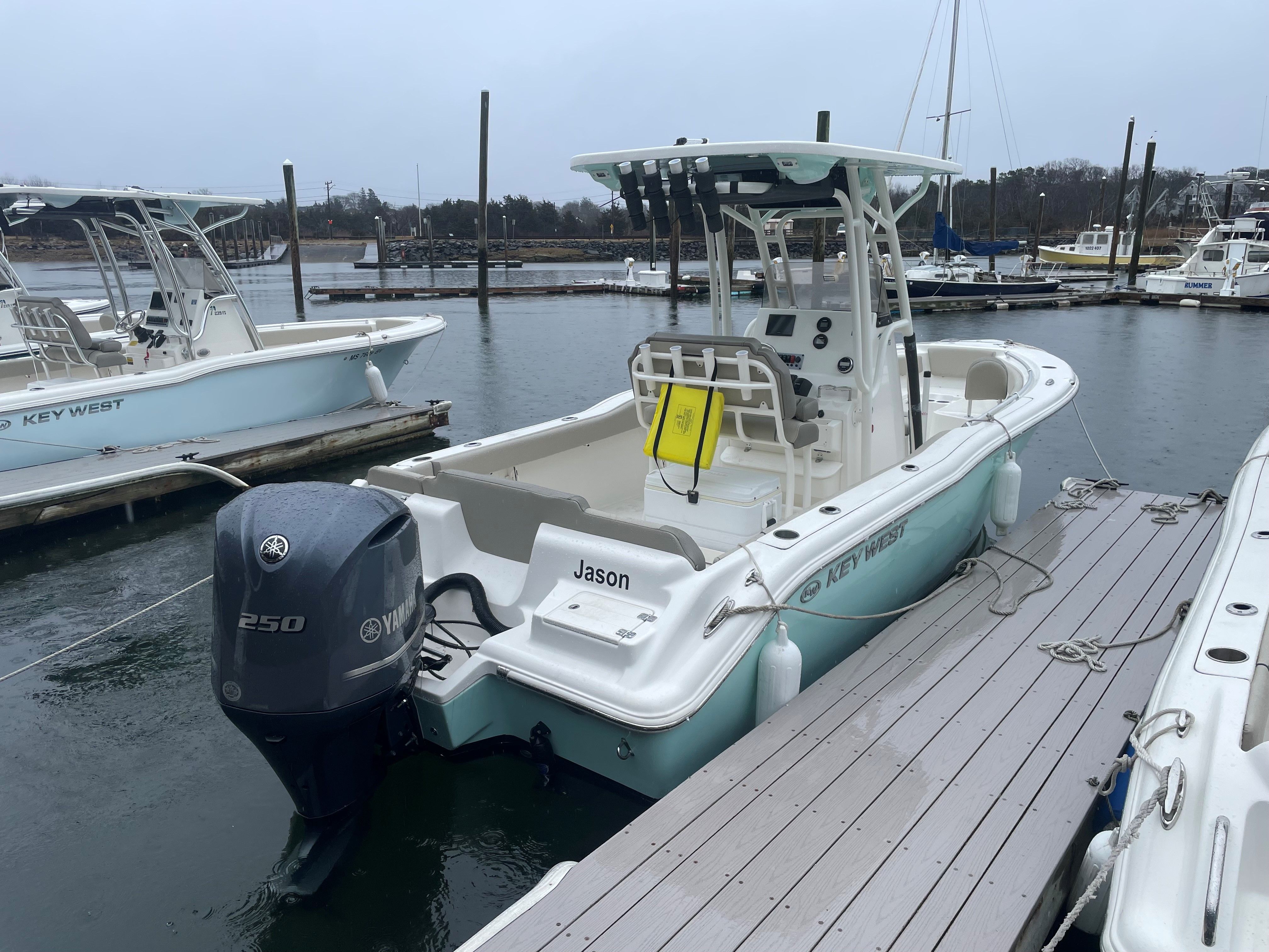 Key West 239 FS 2024 Key West 239 FS boat docked, featuring Yamaha 250 engine, in a marina setting.