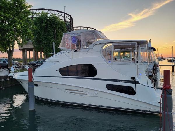 Silverton 39 Motor Yacht 2003 Silverton 39 Motor Yacht docked at sunset, featuring sleek white design.