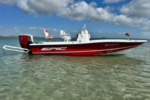 Epic 22 Sport Console 2015 Epic 22 Sport Console boat in shallow water, red and white design, clear sky background.