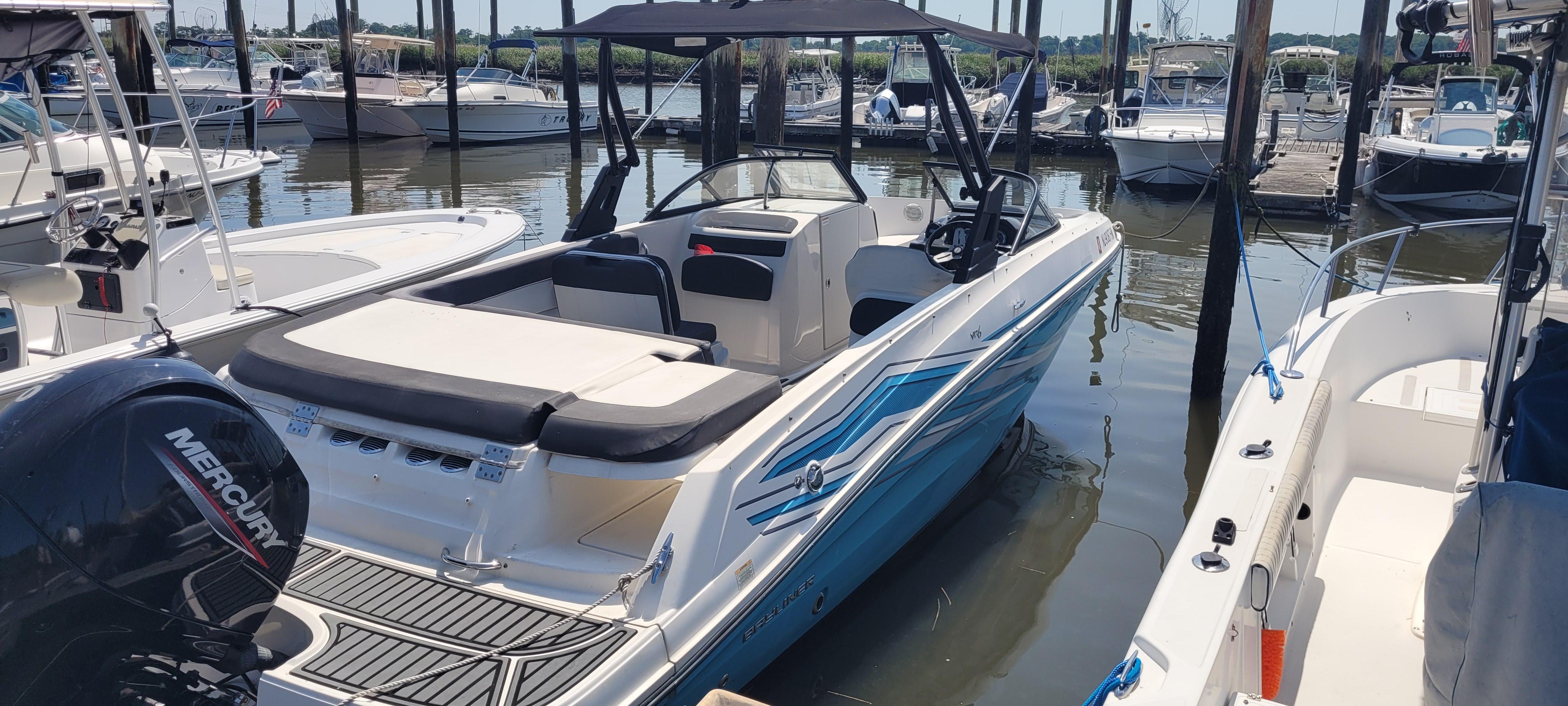 Bayliner VR5 Bowrider OB 2020 Bayliner VR5 Bowrider OB docked in a marina, featuring sleek design and Mercury outboard engine.
