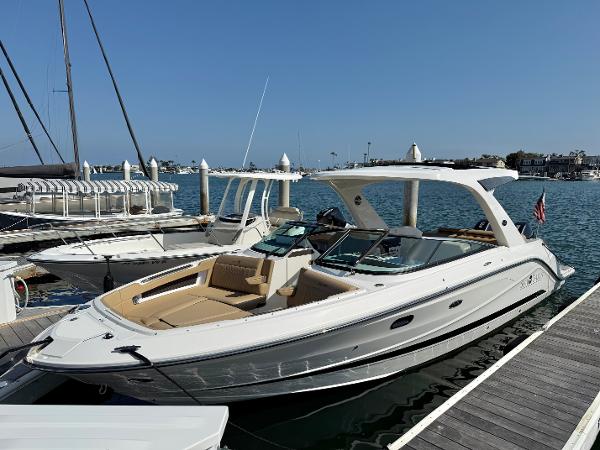 Sea Ray SLX 310 Outboard 2022 Sea Ray SLX 310 OB boat docked at marina under clear blue sky.