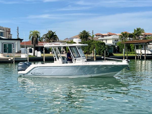 Robalo R272 Center Console 2022 Robalo R272 Center Console boat on calm water near waterfront homes.