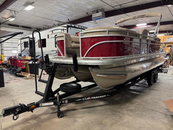Sun Tracker Party Barge 22 XP3 2024 Sun Tracker Party Barge 22 XP3 pontoon boat in a garage setting.