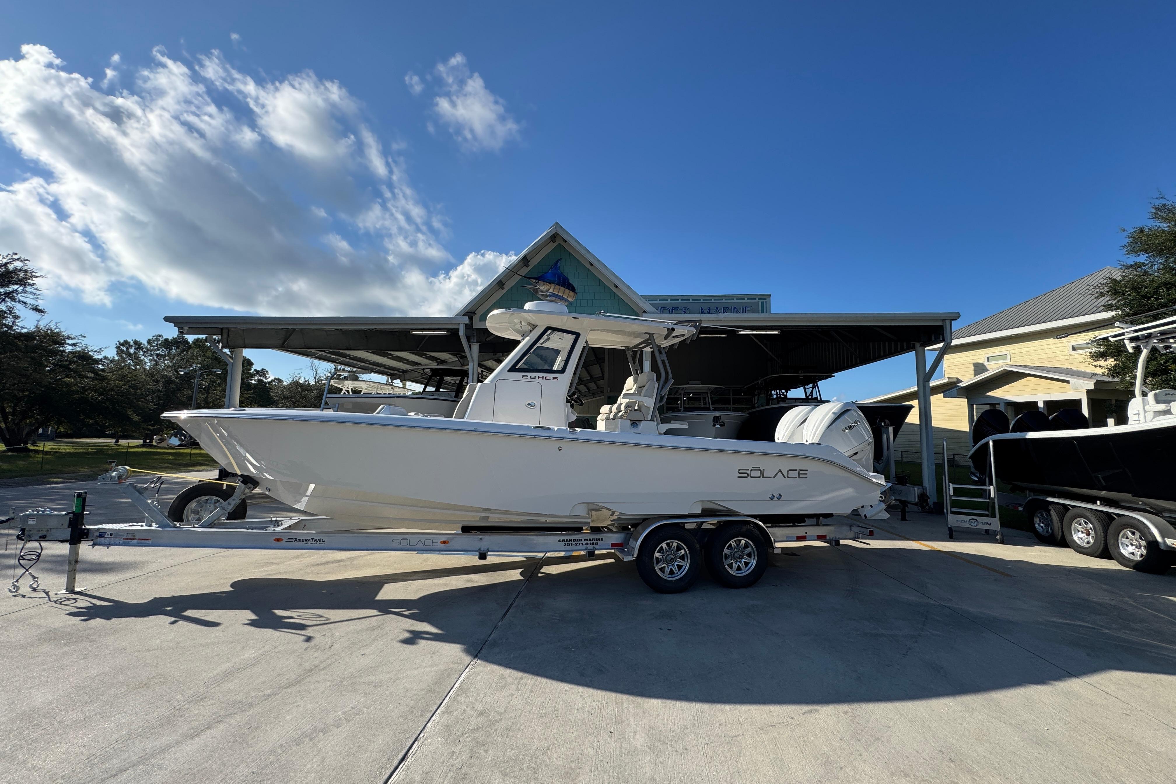 Solace 28 HCS 2026 Solace 28 HCS boat on trailer under clear blue sky.