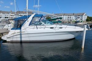 Sea Ray 340 Sundancer 1999 Sea Ray 340 Sundancer docked at marina with blue canopy.