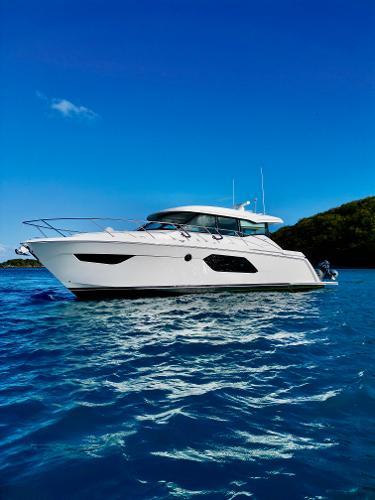 Tiara Yachts C49 Coupe 2023 Tiara Yachts C49 Coupe on blue water under clear sky.