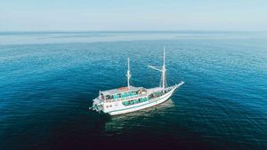 Phinisi Custom Aerial view of 2012 Phinisi Custom boat sailing on calm blue ocean waters.