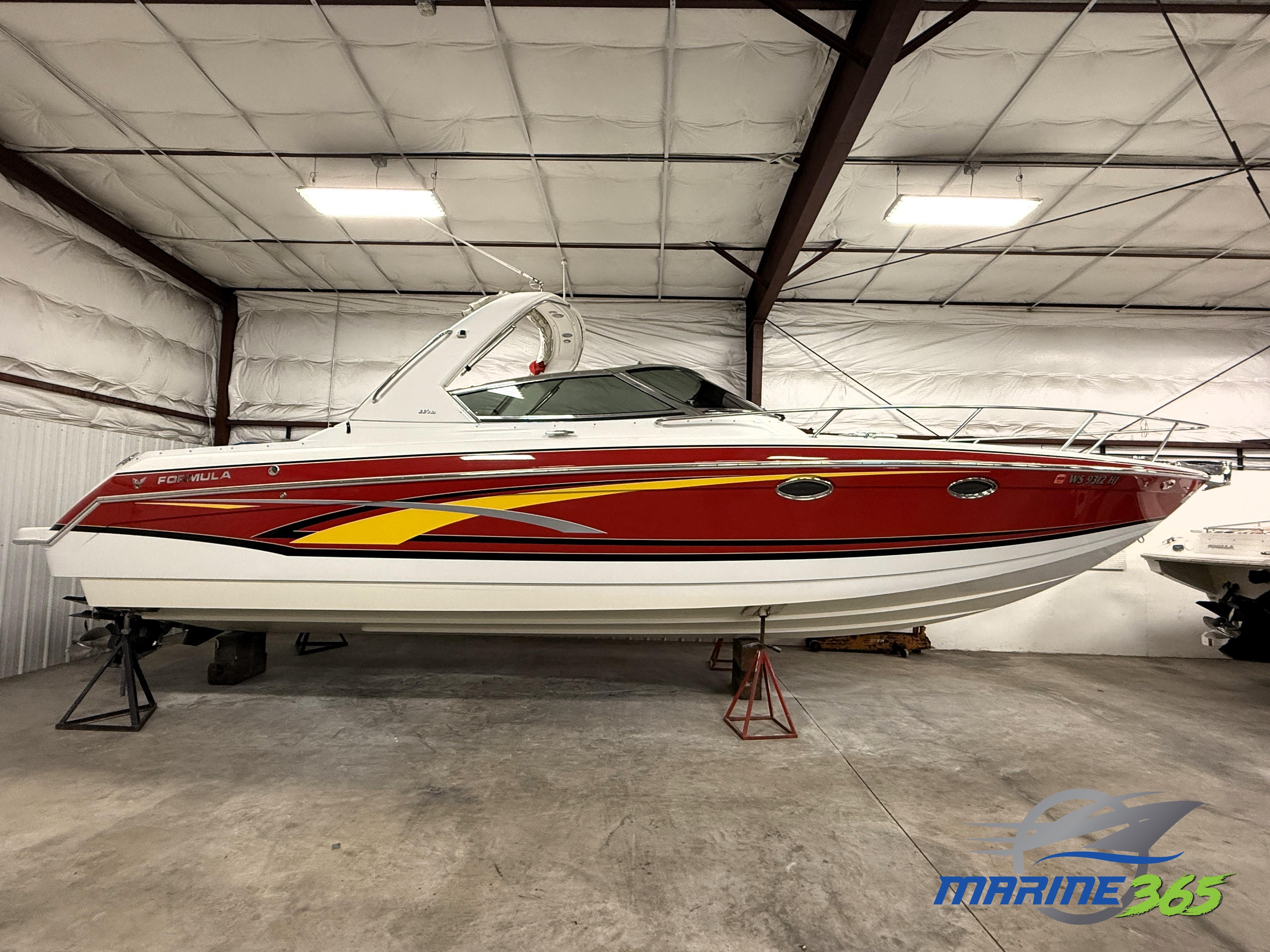 Formula 330 Sun Sport 2008 Formula 330 Sun Sport boat in storage, red and white design, indoor facility.