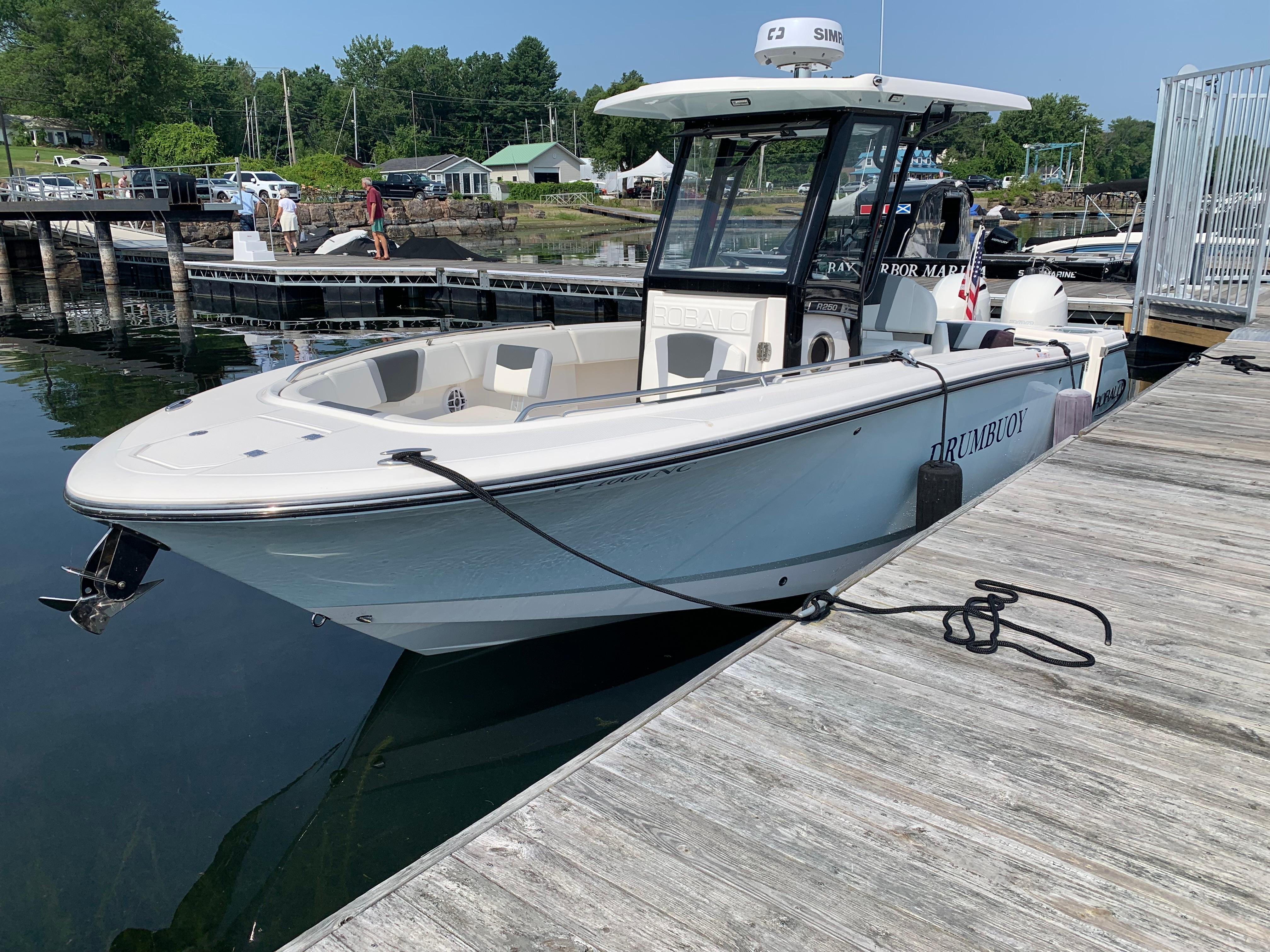 Robalo R250 Center Console 2023 Robalo R250 Center Console boat docked at a marina, sunny day.