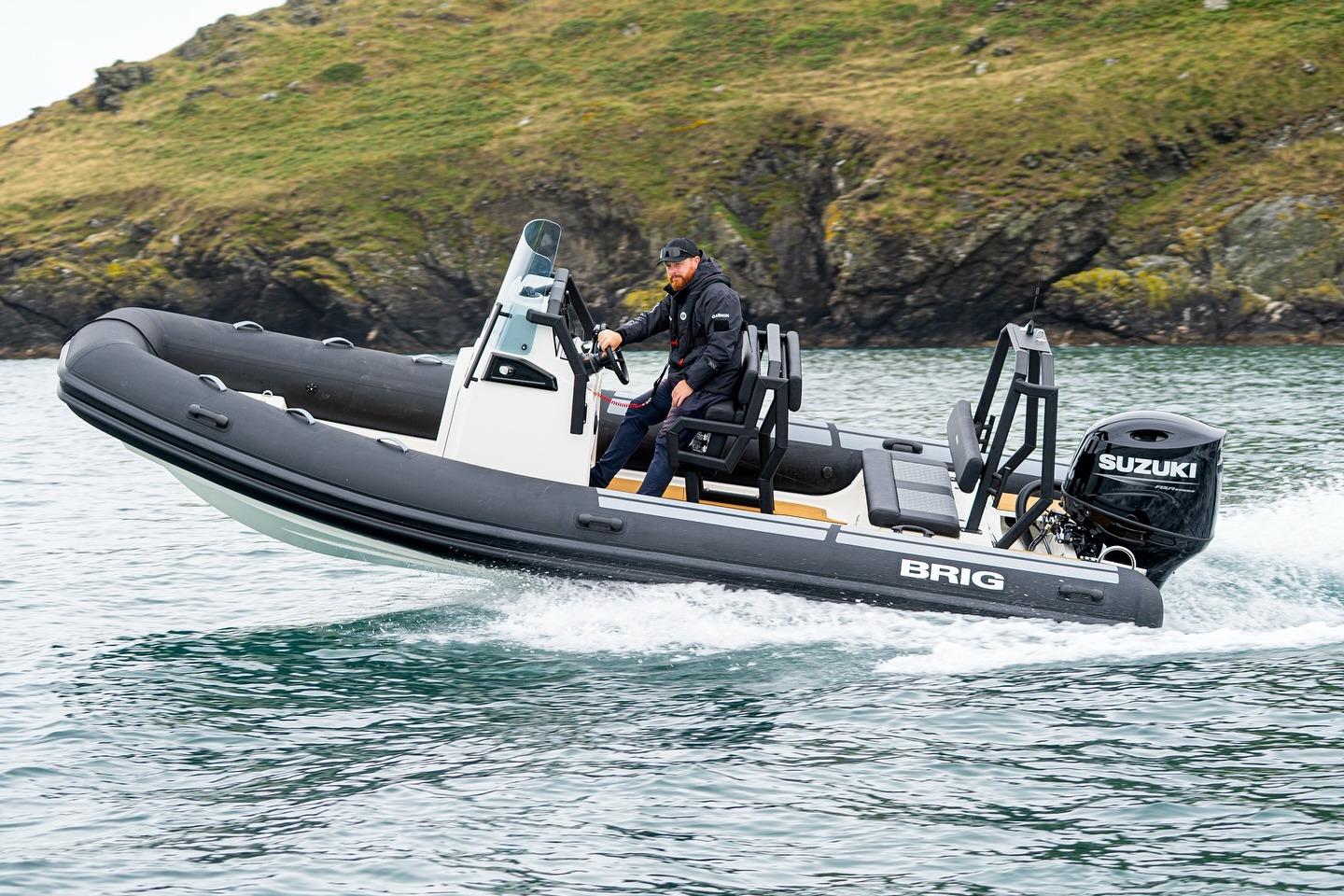 Brig Navigator 20 2026 Brig Navigator 20 boat with Suzuki engine cruising on water near rocky shore.