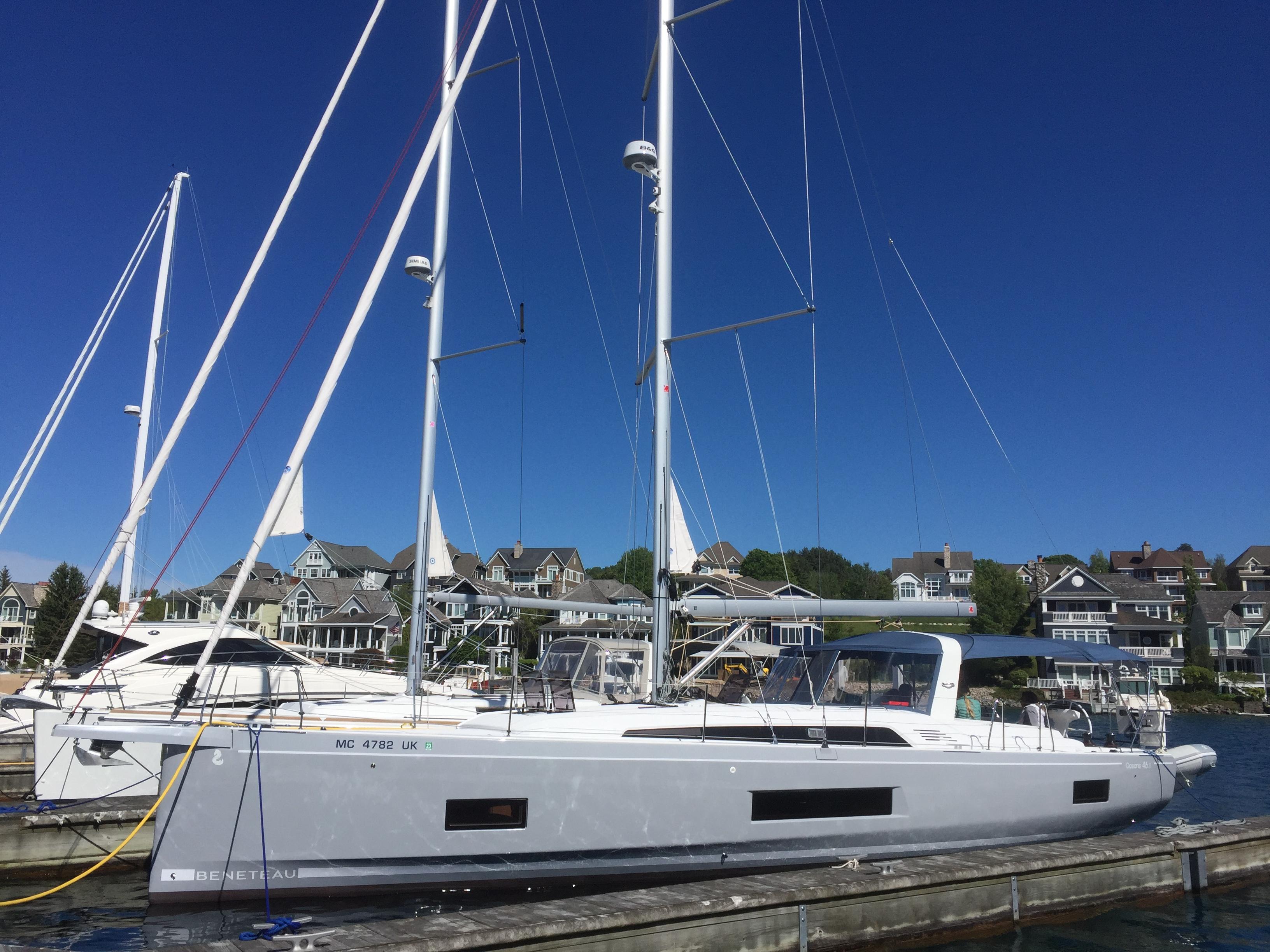 Beneteau Oceanis 46.1 2020 Beneteau Oceanis 46.1 sailboat docked at marina, clear blue sky background.